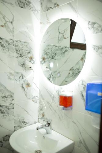 a bathroom with a sink and a mirror at NIISS house in Akhaltsikhe