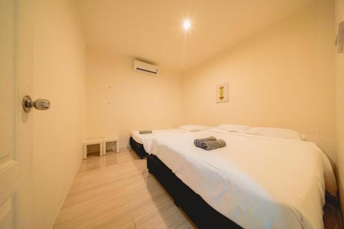 a bedroom with two beds with white sheets at GAO Phala Beachfront Hostel in Ban Phala