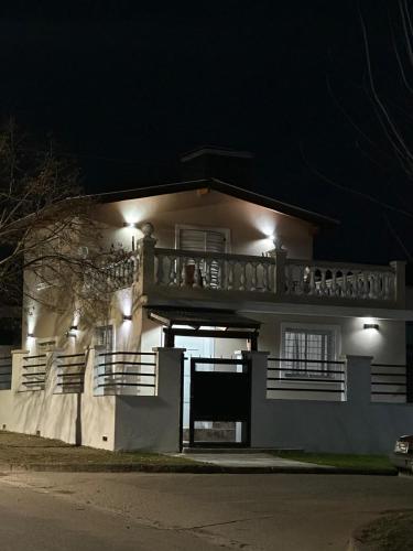 a large white building with a balcony at night at Mí cielo in Huerta Grande