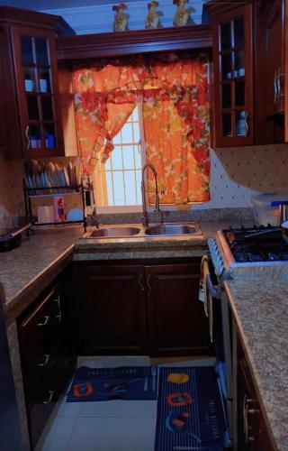 a kitchen with a sink and a stove and a window at Villa panamericana in El Seis