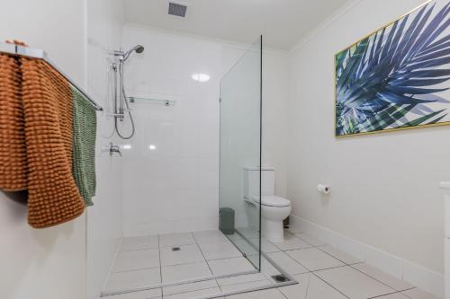 a bathroom with a glass shower and a toilet at Lagoons Resort Apartment 63 in Agnes Water