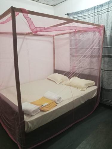 a bed in a tent with two pillows at Ceylon Bay in Arugam Bay