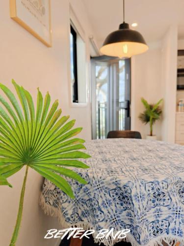 a plant sitting next to a table in a room at Quiet Haven Retreat | Cozy Modern Townhouse in Lower Hutt