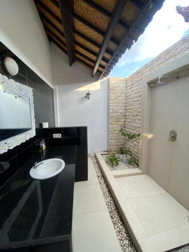 a bathroom with a sink and a mirror at Inti Bungalows in Gili Trawangan