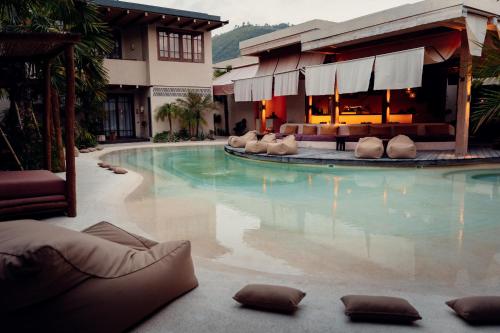 a swimming pool in front of a hotel at Kumbara Oasis Lombok in Kuta Lombok