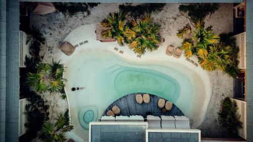 a mural of a pool on a wall at Kumbara Oasis Lombok in Kuta Lombok