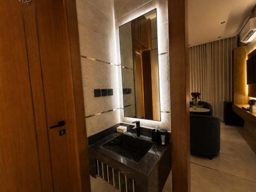 a bathroom with a sink and a mirror at Toot Suites Studio in Abha