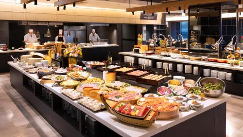 a buffet line with many different types of food at Ooedo Onsen Monogatari Premium Nagasaki Hotel Seifu in Nagasaki