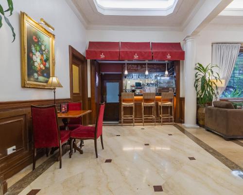 a living room with a table and chairs and a bar at Orchid Garden Suites in Manila