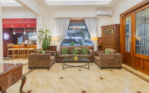 a living room with two couches and a table at Orchid Garden Suites in Manila