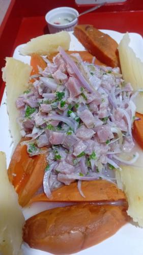 a plate of food with meat and vegetables on it at Hospedaje restaurant Sr de Sipan in Sipán