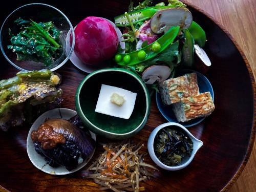 a plate of food with different foods on a table at Malda Kyoto in Kyoto