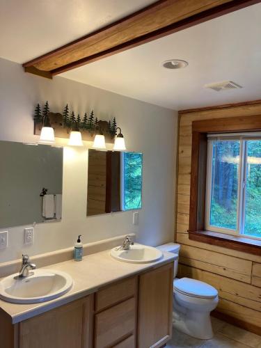 a bathroom with two sinks and a toilet at Beach Roadhouse in Haines