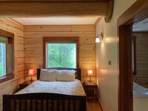 a bedroom with a bed in a log cabin at Beach Roadhouse in Haines
