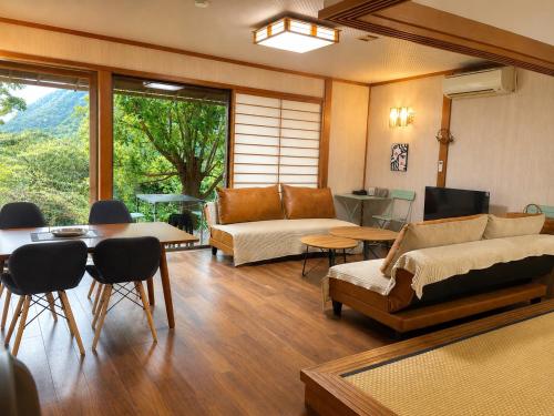 a living room with a couch and a table at 春まち in Ito