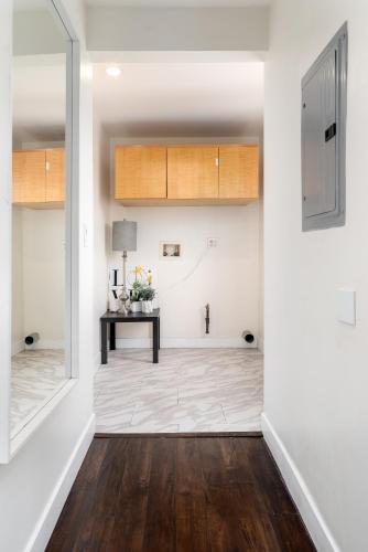 a hallway with white walls and a table in a room at Executive Stay Inn free parking in Oakland