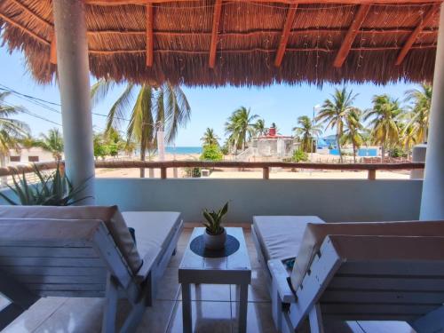 a view of the beach from the porch of a resort at Casa Punta Perula Boutique Hotel in Pérula