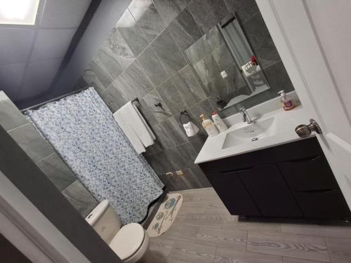a bathroom with a toilet and a sink at Hotel La Estacion in La Unión