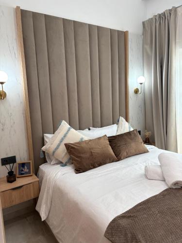 a bedroom with a large bed with white sheets and pillows at Riviera garden 9 in Cabo Negro