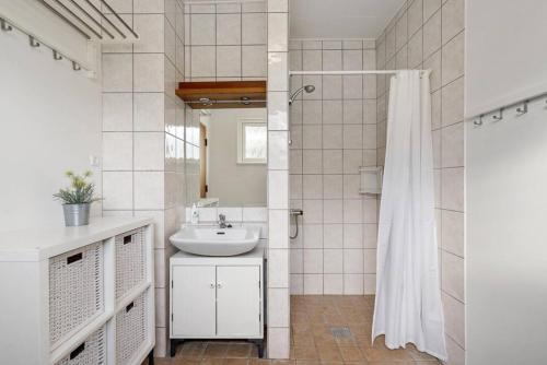 a bathroom with a sink and a shower at Sct Knudsborg - 12C - Apartment on the beach in Brenderup