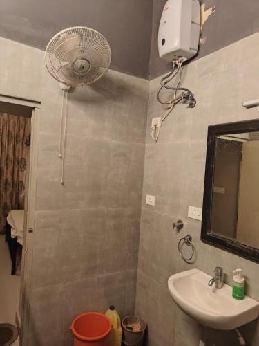 a bathroom with a sink and a fan at Goan Casa Feliz in Calangute