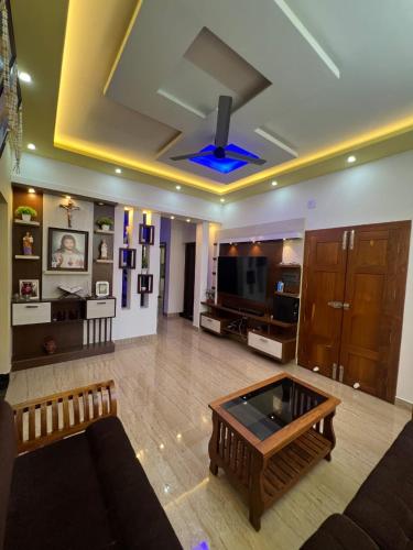a living room with a couch and a coffee table at Kurishingal Guest House in Mararikulam