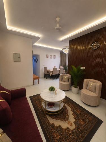 a living room with a couch and a table at Riwaayat & Wings, a luxe stay 5 min from Taj Mahal in Tājganj