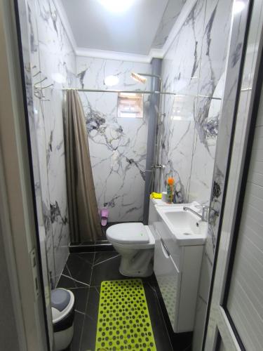 a small bathroom with a sink and a toilet at Амир in Arkit