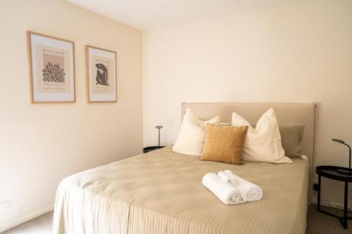 a bedroom with a bed with two towels on it at Southern Peaks Hideaway in Queenstown Airport