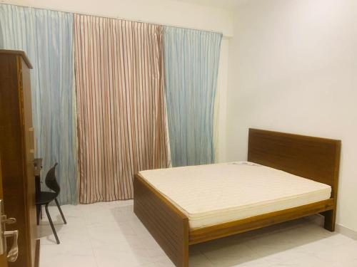 a bedroom with a bed in the corner of a room at Airport Transit Home in Ja-Ela