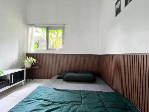 a small bedroom with a bed in the corner at SleepOver BDI2 in Wonosobo