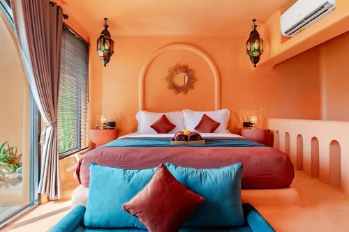 a bedroom with a large bed with colorful pillows at Güzel Villa Bali in Badung