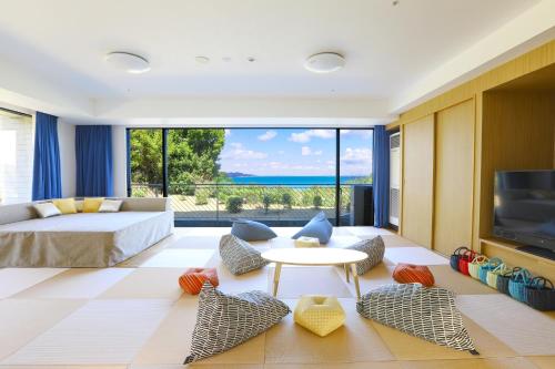 a living room with a bed and a tv at TAOYA Shima in Toba