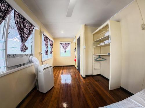 a hallway of a room with a bed and a window at Tanuli Heights in Honiara