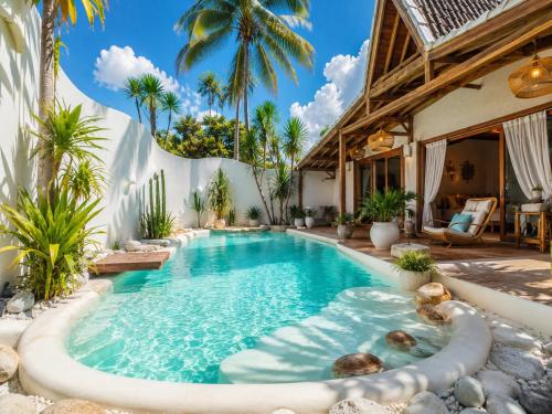 an infinity pool in a backyard with palm trees at Kaleydo Villas in Gili Trawangan