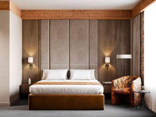 a bedroom with a large bed and a chair at Urban Hotel Ethno in Bishkek
