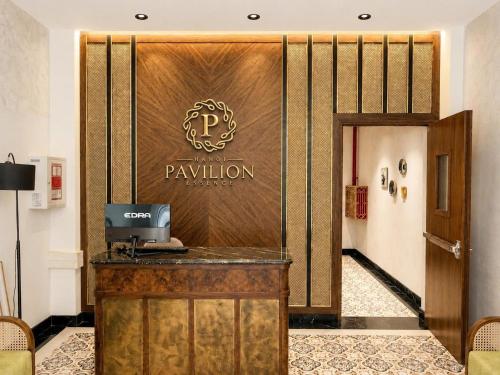 a hotel lobby with a pajilion sign on the wall at Pavilion Essence Hanoi Hotel in Hanoi