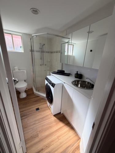 a bathroom with a sink and a washing machine at Surfers 641 in Gold Coast