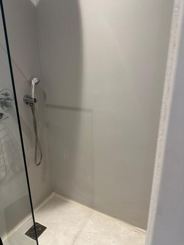 a shower stall with a glass door in a bathroom at Eternal Town in Mikonos