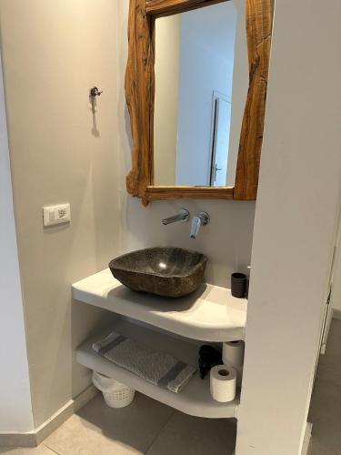 a bathroom with a sink and a mirror at Eternal Town in Mikonos