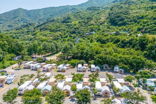 an aerial view of a campground with mountains in the background at Jirisan Forest Caravan Park in Gurye