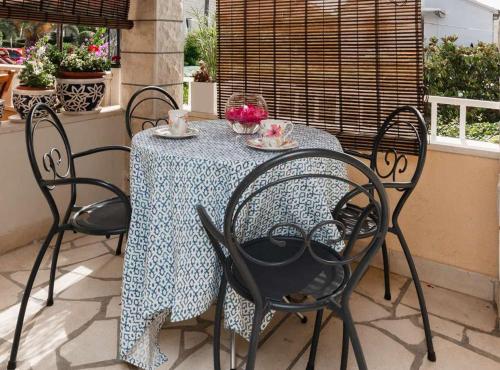 a table with chairs and a blue and white table cloth at Apartments Roda in Supetar