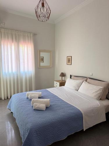 a bedroom with a large bed with two towels on it at Olivia 42 in Nafpaktos
