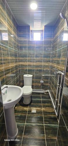 a bathroom with a toilet and a sink at Magnato Hostel in Andizhan