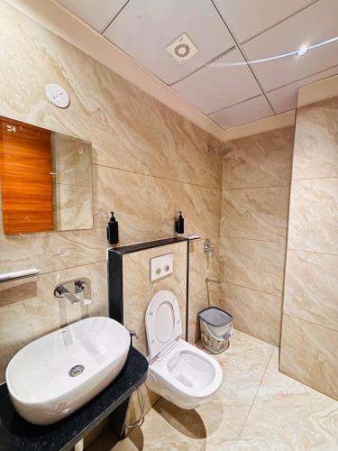 a bathroom with a white toilet and a sink at Hotel janki elite in Jaipur