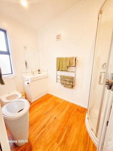 a bathroom with a shower and a toilet and a sink at The She Oak in Carterton