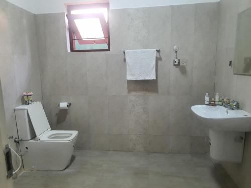 a bathroom with a toilet and a sink at Dee Holidays - in Moratuwa