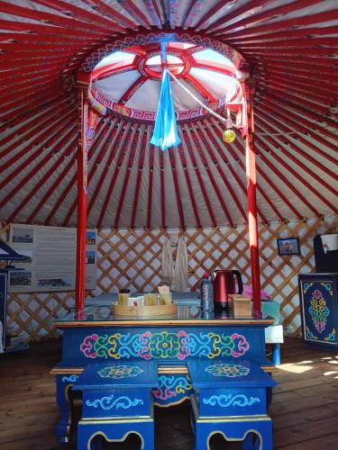 a large yurt with a table in it at Notre yourte mongole in Chevinay