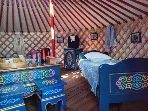 a bedroom with a bed in a yurt at Notre yourte mongole in Chevinay