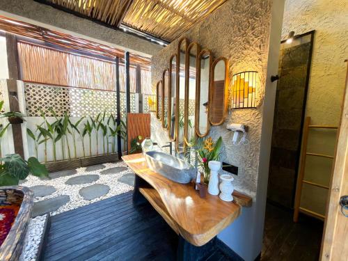 a bathroom with a sink and mirrors on the wall at Beachview Villa near Sanur, Live Sports AFL NRL in Ketewel